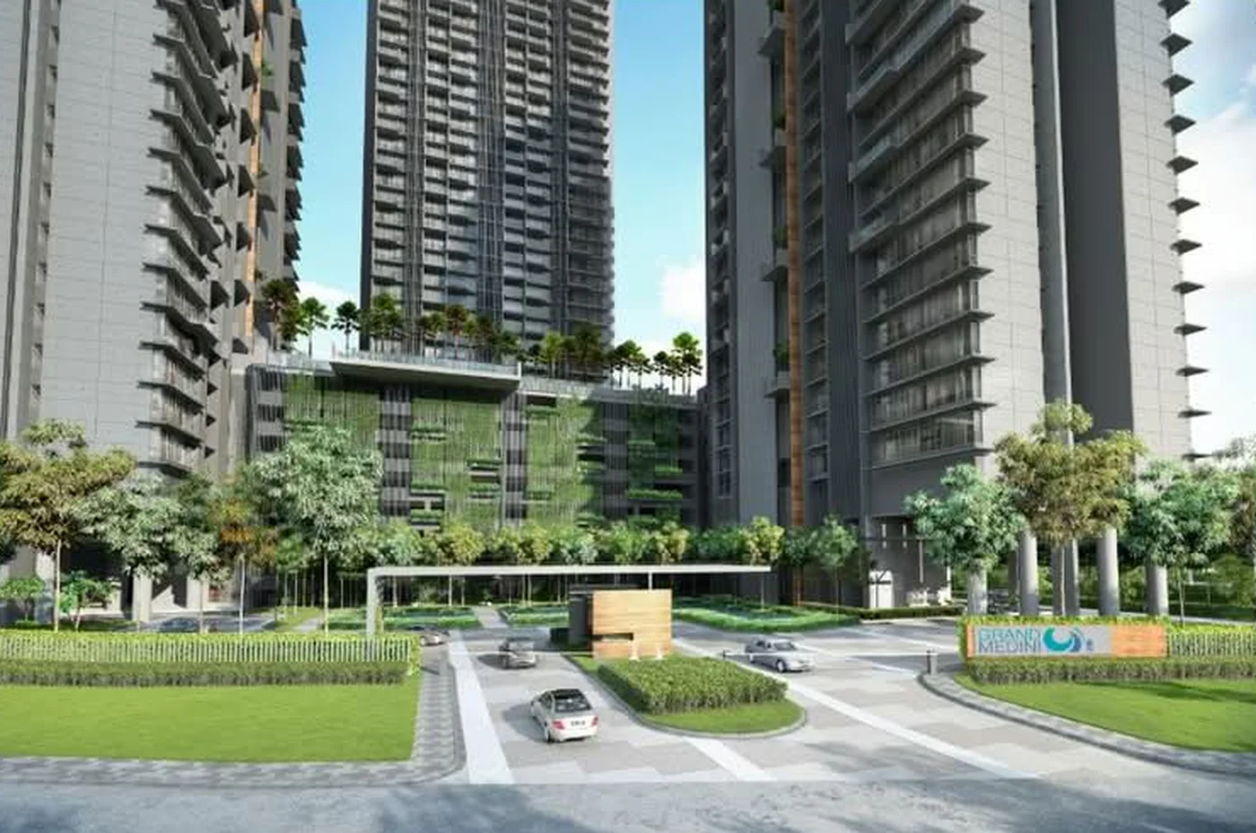Grand Medini's landscaped entrance drive with the project signage, vertical green facade and drop-off court